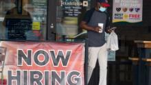 FILE - In this Sept. 2, 2020, file photo, a customer walks past a now hiring sign at an eatery in Richardson, Texas. The Labor Department reported unemployment numbers Thursday, Sept. 3. (AP Photo/LM Otero, File)