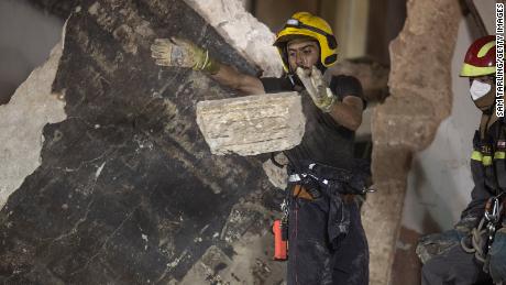 Rescue workers clear rubble from a destroyed building with the aim of finding a potential survivor on September 4, 2020 in Beirut, Lebanon. 