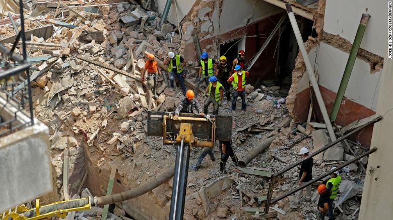 Rescue workers dig through the ruins of a badly damaged building on September 4.