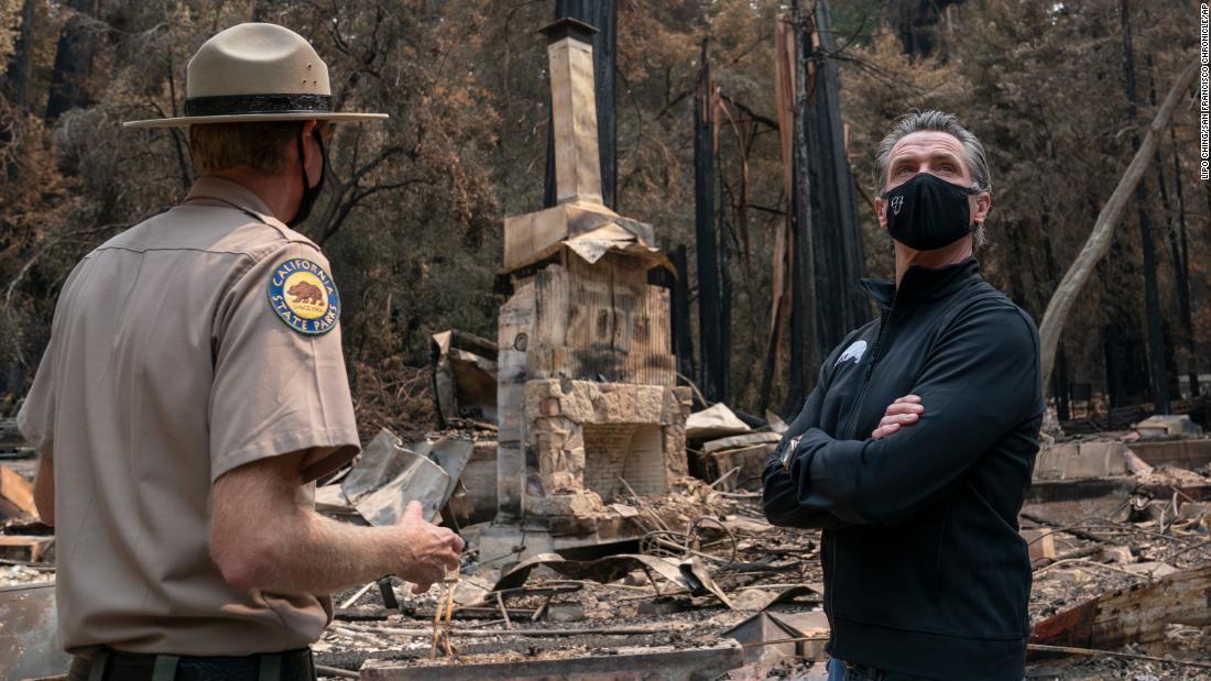 California Gov. Gavin Newsom, right, listens as Santa Cruz State Park Superintendent Chris Spohrer talks about the fire damage to the Big Basin Redwoods State Park.