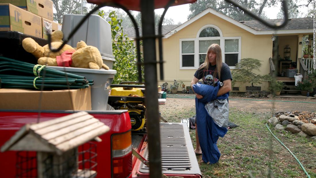 Randy Hunt packs up his belongings, including his daughter Natasha&#39;s first Pooh bear, left, in case he and his wife Sheli had to evacuate the home they rent in Middletown, California, on August 26, 2020.
