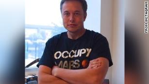 Musk, in a photo posted to his Instagram, wears one of SpaceX&#39;s &quot;Occupy Mars&quot; t-shirts.