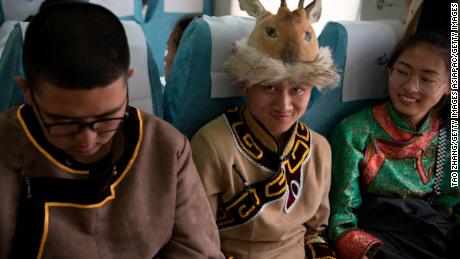 Students in traditional clothing travel on a special train to attend university entrance exam in Inner Mongolia, China in June, 2019.