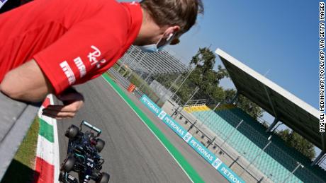 Sebastian Vettel watches his rival Lewis Hamilton take pole position.