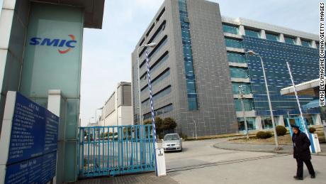 A security guard guards the office building of Semiconductor Manufacturing International Corp (SMIC) in Shanghai, China, on March 12, 2012.