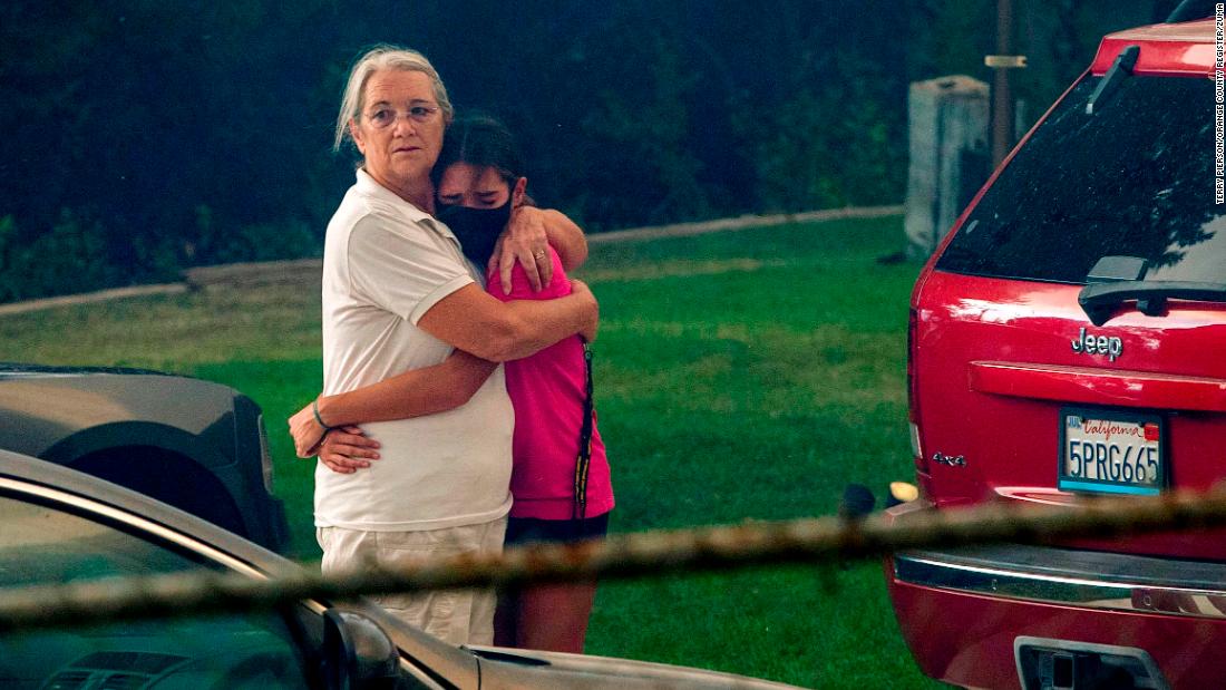 Family members comfort each other as the El Dorado Fire moves closer to their home in Yucaipa, California, on September 6, 2020.