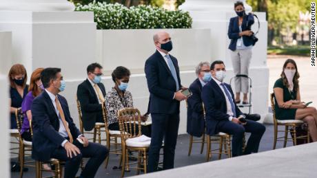 Reuters correspondent Jeff Mason (center) would not remove his face mask at the request of the President. 