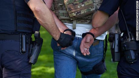 A man is handcuffed by Oregon police in Salem on September 7.
