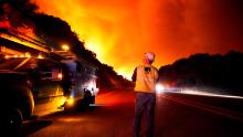 A Pacific Gas and Electric worker looks up at the advancing Creek Fire near Alder Springs, California, on Tuesday, September 8.