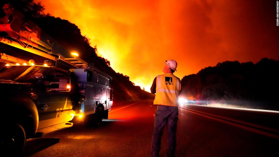 A Pacific Gas and Electric worker looks up at the advancing Creek Fire near Alder Springs, California, on September 8, 2020.