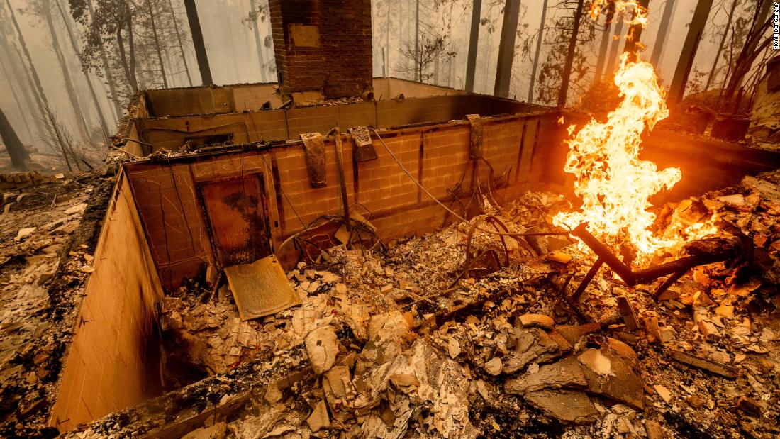 Flames burn at a home leveled by the Creek Fire in Fresno County, California.