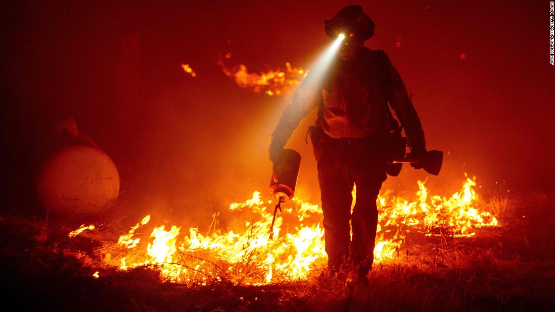 Firefighters cut defensive lines and light backfires to protect structures in Butte County, California, on September 9, 2020.