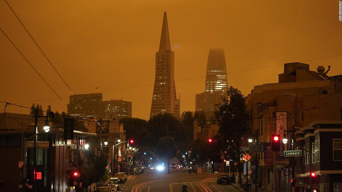 Looking up San Francisco&#39;s Columbus Avenue, the Transamerica Pyramid and Salesforce Tower are covered with smoke from nearby wildfires on September 9. This photo was taken in the late morning.