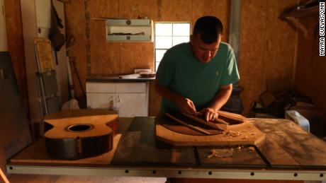 Earl Moore works on a guitar he made from scratch. He credits wood working, in large part, for eight years of sobriety. 