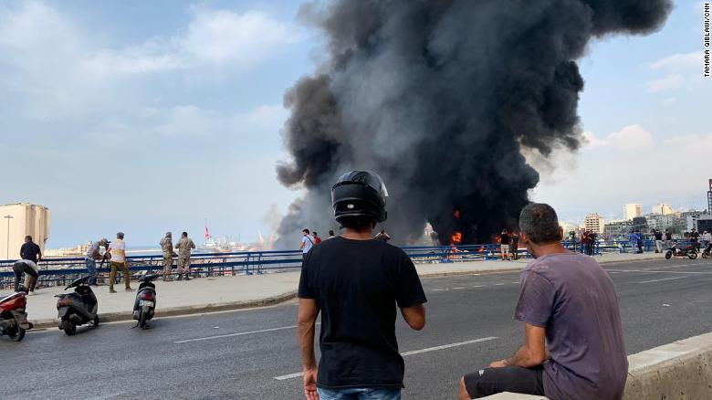 Onlookers watch the blaze near the port.