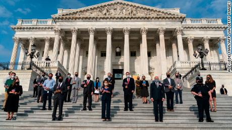 US House Speaker Nancy Pelosi, center, leads House members in a moment of silence at the US Capitol in Washington, DC.