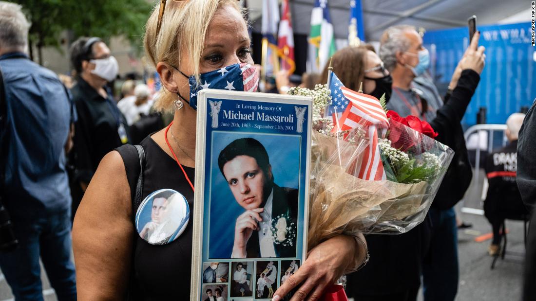 Diane Massaroli holds photos of her husband who was killed in the attack. Michael Massaroli was 38. He was a vice president at a financial services company, and he worked on the 101st floor of the original One World Trade Center.