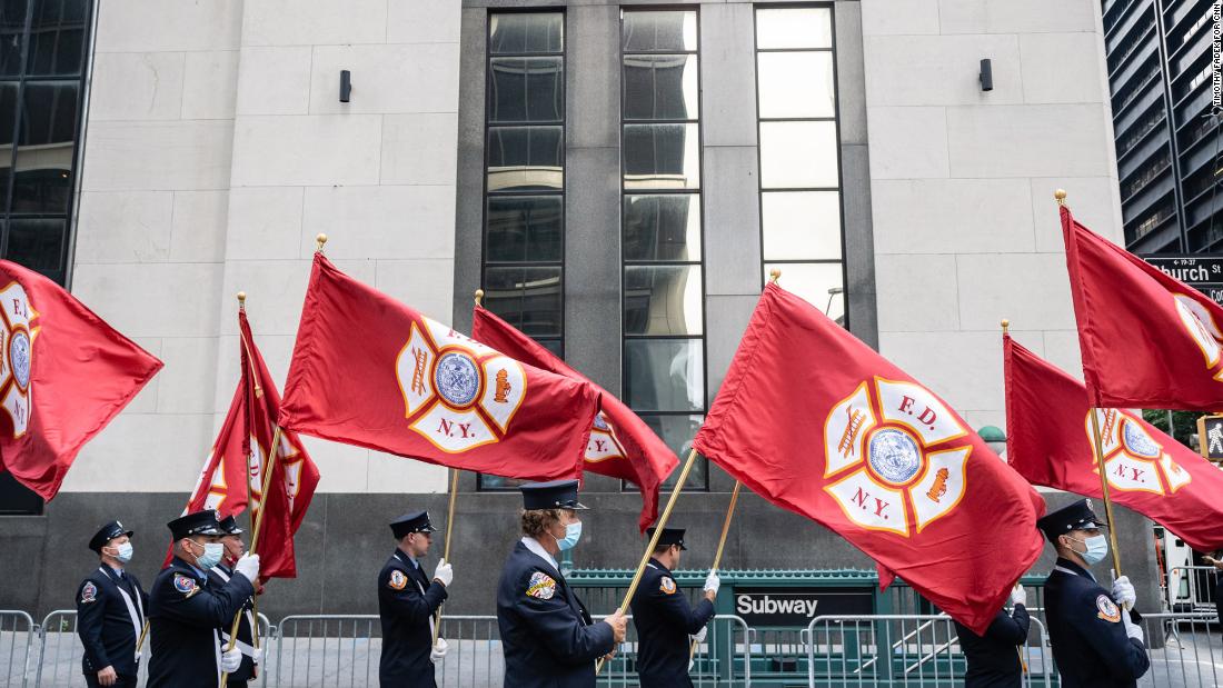 Firefighters prepare to march near the World Trade Center.