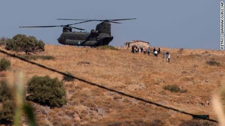 A military helicopter atop a hill on the Greek island of Lesbos on Friday, as police were deployed to the site of a new refugee camp. 