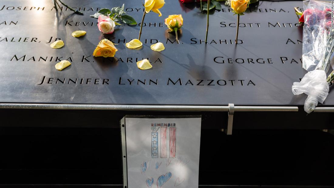 Flowers and a drawing are placed at the 9/11 Memorial.