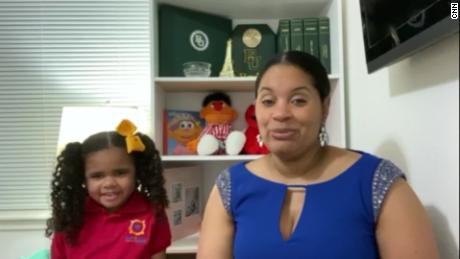 Krystle Ragston and her daughter ask a question during the town hall.