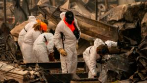 Search and rescue personnel from the Jackson County Sheriff&#39;s Office look for the possible remains of a missing elderly resident in a mobile home park on September 11, 2020 in Ashland, Oregon. 