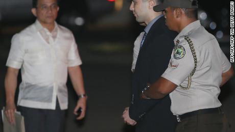 Lance Cpl. Joseph Scott Pemberton is escorted by Philippine policemen after arriving at Camp Aguinaldo in Quezon City, Philippines on December 1, 2015.