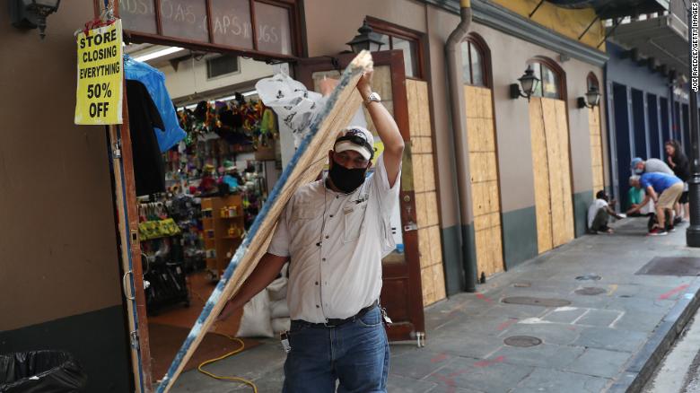 Luis A. Sanabria puts plywood over windows of a business in the French Quarter in New Orleans.