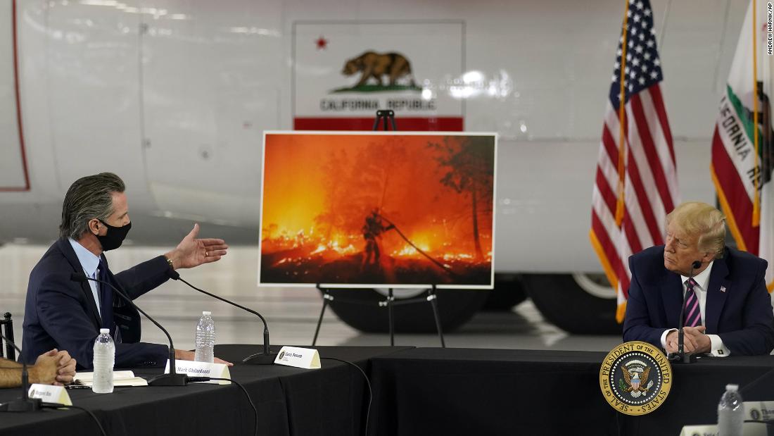 President Donald Trump listens as California Gov. Gavin Newsom speaks about the wildfires during a briefing on September 14, 2020.