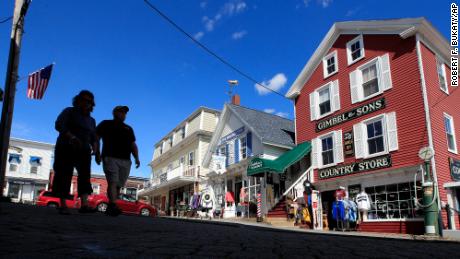 Tourists walk by shops in Boothbay Harbor, Maine in June. By early September, Maine&#39;s economy was operating at 93% of where it was before the pandemic, according to the Back-to-Normal Index. (AP Photo/Robert F. Bukaty)