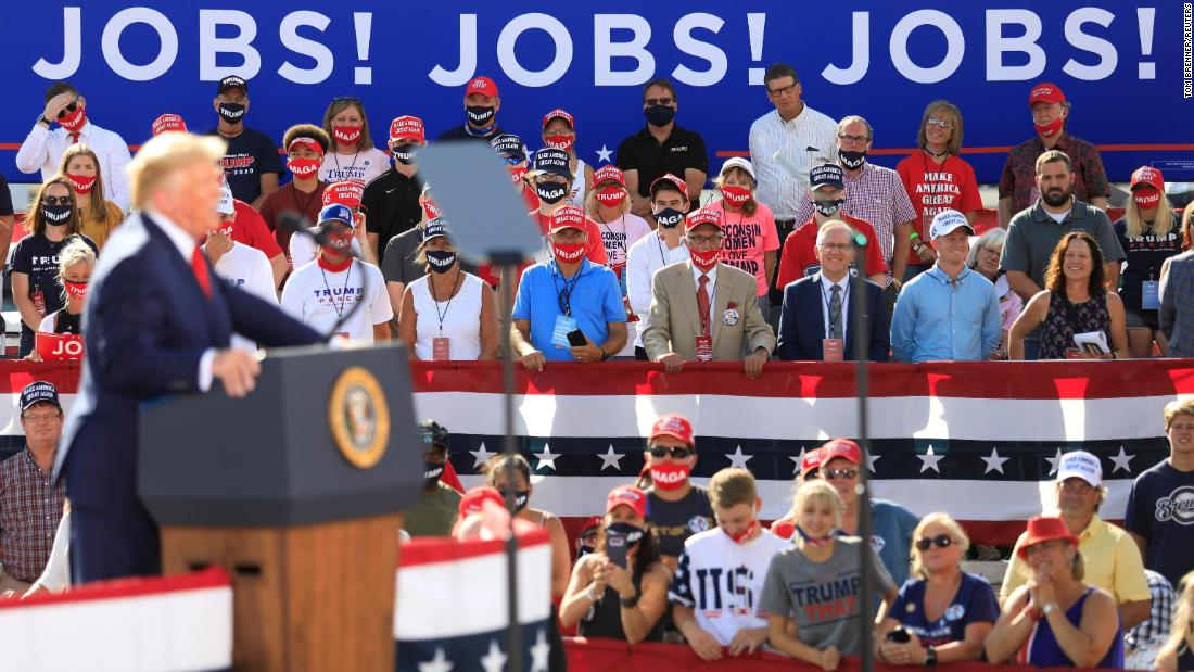 Supporters look on as Trump delivers remarks at a rally in Oshkosh, Wisconsin, in August 2020.