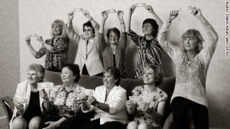 Members of the Original 9 recreate an old photo where they posed with one dollar bills having signed to compete in the Virginia Slims Circuit. 