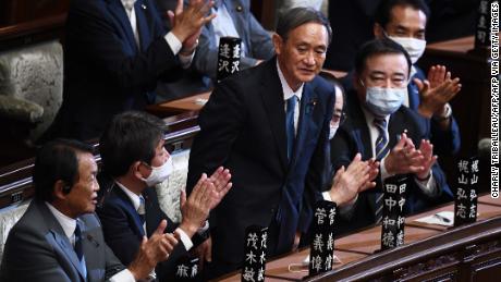 Yoshihide Suga is applauded after he was elected as Japan&#39;s Prime Minister by the lower house of the Diet in Tokyo on September 16.