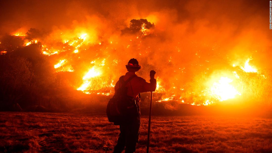 A firefighter works at the scene of the Bobcat Fire burning on hillsides near Monrovia, California, on September 15, 2020.