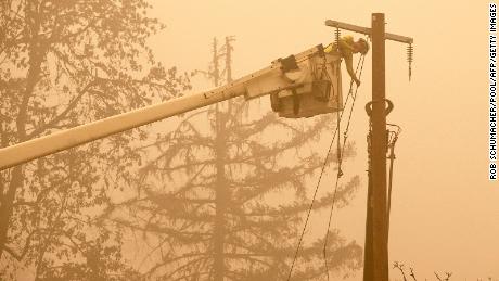 Workers continue to repair the power system after flames from the Beachie Creek Fire burned through Fishermen&#39;s Bend Recreation Site in Mill City, Oregon.