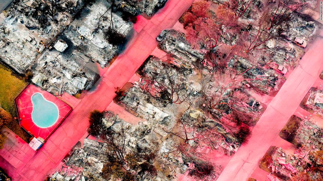 In this aerial photo taken with a drone, red fire retardant sits on leveled homes in Talent, Oregon, on September 15.