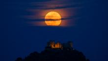 A full (blue) moon rises over Almodovar del Rio Castle on March 31, 2018, in Spain.