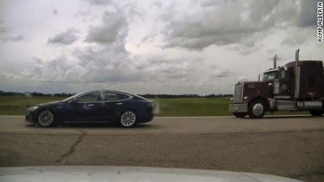 Canadian police have charged a 20-year-old man with dangerous driving after he was found apparently asleep at the wheel of a Tesla.