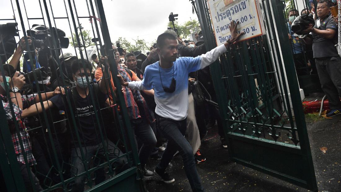 Anti-government protesters led by activist Panupong &quot;Mike&quot; Jadnok, center, break through a gate at Thammasat University as they arrive for a pro-democracy rally on September 19.