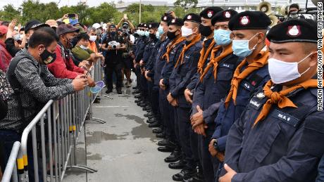 Security forces stand guard as anti-government protesters take part in a rally in Bangkok on September 19.