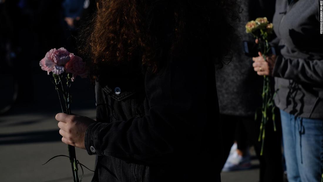People bring flowers to the Supreme Court on September 19.
