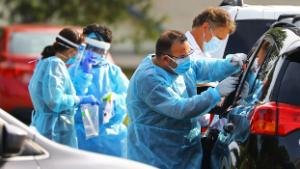 A medical professional administers a Covid-19 test at a free testing site at the Endicott Estate in Dedham, Massachusetts on September 14, 2020. Fallon Ambulance is conducting the testing during the continuing coronavirus pandemic. (Photo by Pat Greenhouse/The Boston Globe via Getty Images)