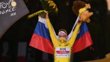 Slovenia's Tadej Pogacar wearing the overall leader's yellow jersey celebrates on the podium after winning the 107th edition of the Tour de France cycling race.