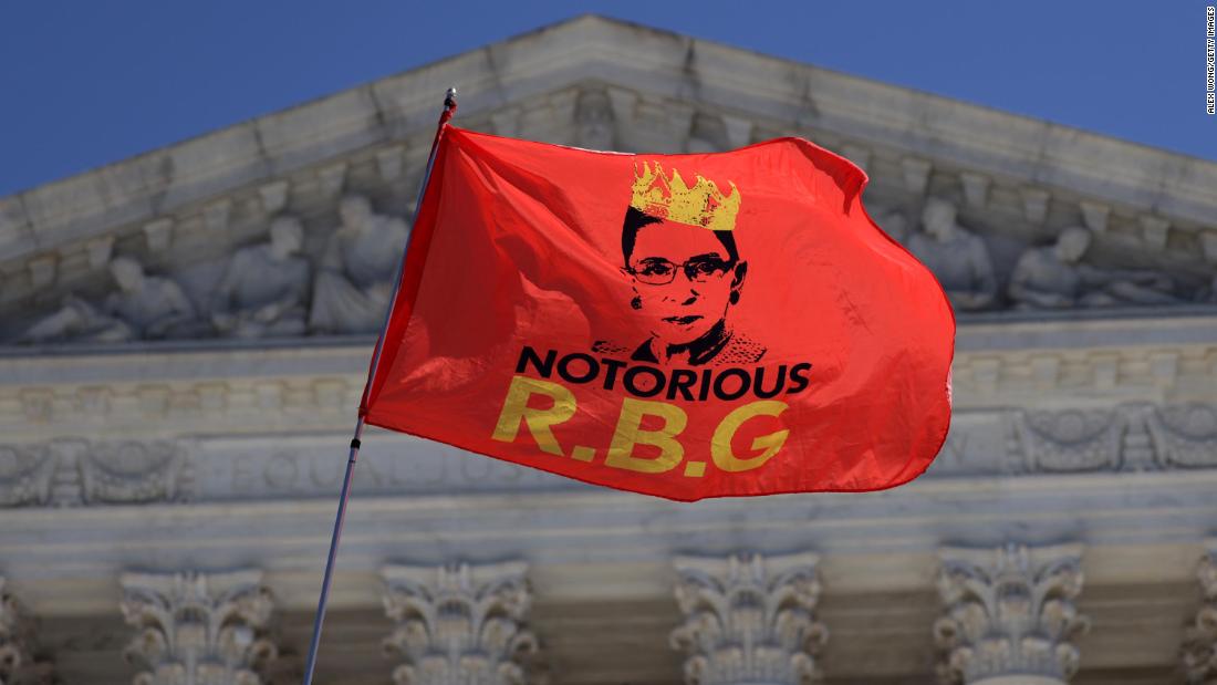 Ginsburg is seen on a flag that someone was waving in front of the Supreme Court on September 21.