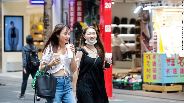 Pedestrians walk with their bubble tea drinks in the Ximending shopping district in Taipei, Taiwan, on July 30, 2020. 