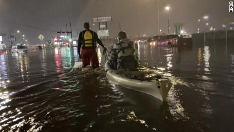 A man is pulled to safety in a kayak after being rescued from his vehicle that had stalled in floodwaters caused by Tropical Storm Beta in Houston on Sept. 21, 2020. 