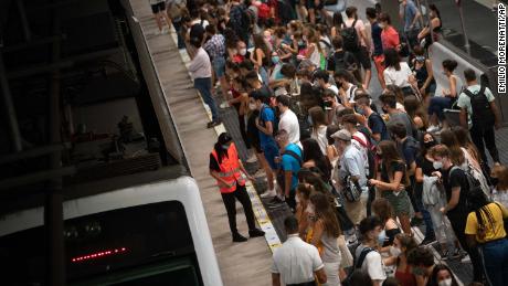 Students wait for a train to university, during rush hour in Barcelona, Spain, on Thursday.