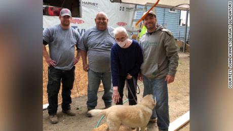 Gloria Scott is surrounded by members of the &quot;Gloria&#39;s Gladiators&quot; team that is rebuilding her home. 