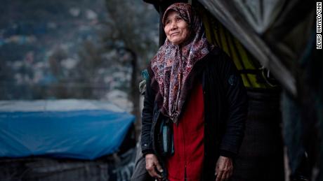 A woman stands outside her tent in the Moria refugee camp in Lesbos, Greece in February 2020. 