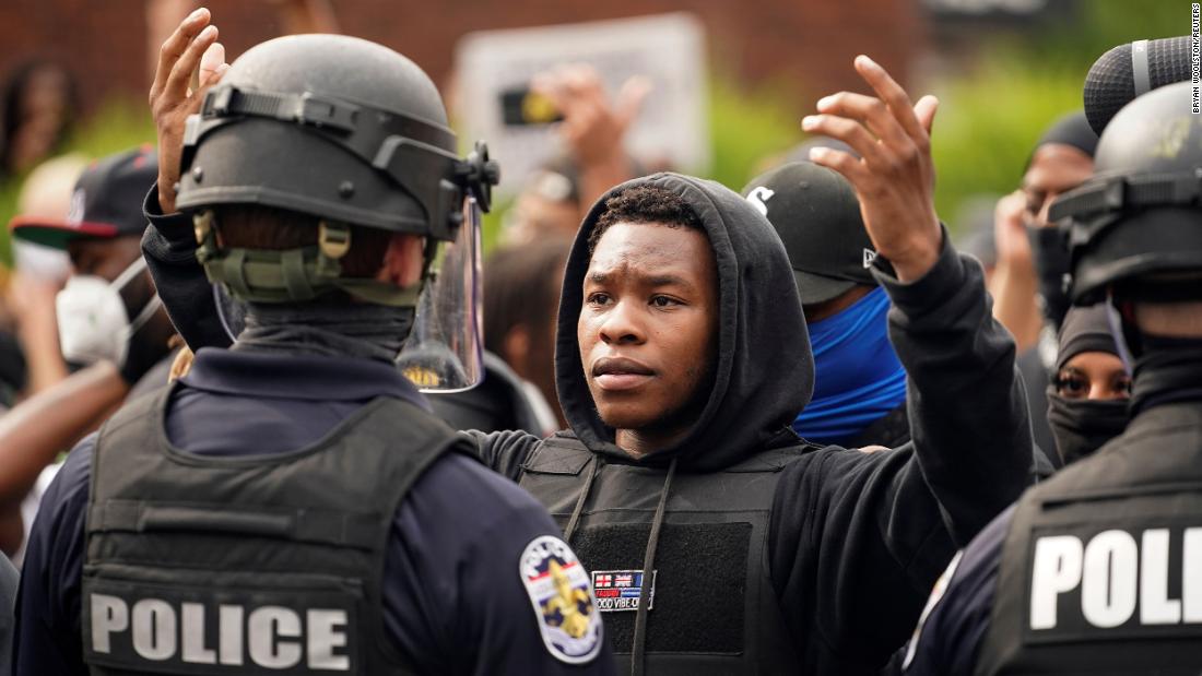 A demonstrator in Louisville confronts a police officer.